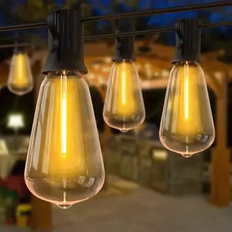 Festoon string lights with ST38 water drop-shaped globes illuminating an outdoor patio scene.